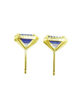 Emerald cut blue sapphire stud earrings with halo diamonds in 14K yellow gold.