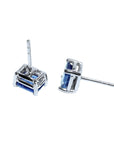 Pair of emerald-cut natural sapphire stud earrings in 14K white gold with four-prong basket settings.