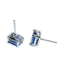 Pair of emerald-cut natural sapphire stud earrings in 14K white gold with four-prong basket settings.