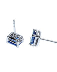 Pair of emerald-cut natural sapphire stud earrings in 14K white gold with four-prong basket settings.