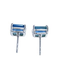 Pair of emerald-cut deep blue sapphire stud earrings in 14K white gold, with prong settings and friction backs.