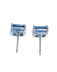 Pair of emerald-cut deep blue sapphire stud earrings in 14K white gold, with prong settings and friction backs.