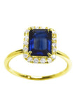 Women's natural blue sapphire ring halo diamond in 14k yellow gold, showcasing a rich medium dark blue hue.