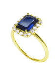 Women's 14k yellow gold ring with emerald-cut blue sapphire and diamond halo.