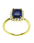 Women's 14k yellow gold ring with a rectangular emerald cut blue sapphire and diamond halo.