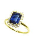 Women's 14k yellow gold ring with emerald cut natural blue sapphire and diamond halo.