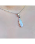 1.56 ct bluish-green opal pendant in 14K white gold, worn on a delicate chain.
