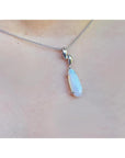 1.56 ct bluish-green opal pendant in 14K white gold, worn on a delicate chain.