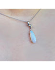 1.56 ct bluish-green opal pendant in 14K white gold, worn on a delicate chain.