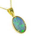 A natural Australian opal pendant with gold setting on a right-side profile position displaying the top and frame.
