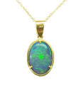 Oval bluish-green Australian opal pendant in 14K yellow gold with three prongs on a delicate chain.