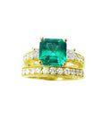 Emerald ring bridal style with accent diamonds and matching band made in 14k yellow gold.