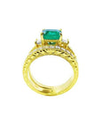 14K yellow gold bridal emerald ring set with matching engraved wedding band and princess cut side diamonds.