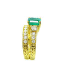 The side view of a bridal emerald ring and matching band, showing the top gemstone and side profiles.