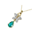 14K gold butterfly pendant with pavé diamonds and a pear-shaped Colombian emerald.
