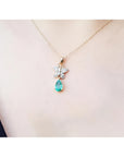 14K gold butterfly pendant with pavé diamonds and a pear-shaped Colombian emerald.