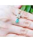 14K gold butterfly pendant with pavé diamonds and a pear-shaped Colombian emerald.
