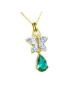 Gold necklace with a natural emerald teardrop pendant and butterfly design on a topside view.