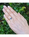 Two-stone "You and Me" blue natural sapphire bypass ring featuring a sparkling teardrop diamond on the side.