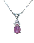 This necklace pendant slider showcases a natural oval pink sapphire cabochon and is crafted in 14k white gold.