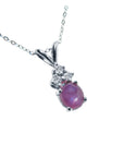 This 14k white gold necklace pendant slider showcases a natural oval pink sapphire cabochon.