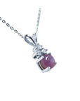 A natural pink sapphire necklace with pendant in 14k white gold.