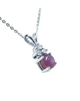 A natural pink sapphire necklace with pendant in 14k white gold.