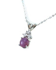 Oval cabochon pink sapphire pendant necklace in 14k white gold.