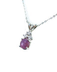 Oval cabochon pink sapphire pendant necklace in 14k white gold.