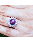 Red purple cabochon star ruby women's ring gemstone on a hand