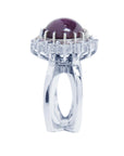 Red purple cabochon star ruby women's ring side top view in a double halo natural diamonds