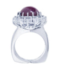 Red purple cabochon star ruby women's ring tall top view in a double halo natural diamonds