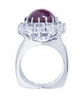 Red purple cabochon star ruby women's ring tall top view in a double halo natural diamonds