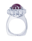 Red purple cabochon star ruby women's ring tall top view in a double halo natural diamonds
