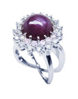 Red purple cabochon star ruby women's ring top side view in a double halo natural diamonds