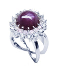 Red purple cabochon star ruby women's ring top side view in a double halo natural diamonds