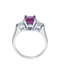 Women's 14k white gold ring with a deep red ruby and trillion side diamonds.