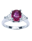 Women's 14k white gold ring with a deep red oval ruby and two trillion side diamonds.