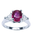 Women's 14k white gold ring with a deep red oval ruby and two trillion side diamonds.