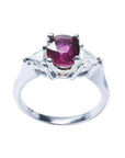 Women's 14k white gold ring with a deep red ruby and trillion side diamonds.