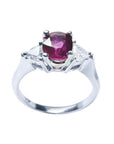 Women's 14k white gold ring with a deep red ruby and trillion side diamonds.