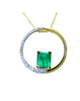 A yellow gold circle of life pendant necklace with a center square natural colombian emerald made of 14k gold.