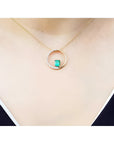 14K gold "Circle of Life" emerald pendant with natural diamonds on a delicate chain.