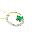 1.08 ct emerald and diamond circle pendant in 14K gold, with a half pavé diamond band.
