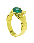 The half side position of this emerald claddagh ring in yellow gold shows the top and side profile.