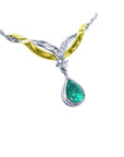A close sight of a dangling teardrop real Colombian emerald necklace, made in 14k yellow and white gold