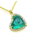 18k yellow gold tilted heart emerald necklace with a halo diamond