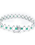 14K white gold bracelet with round Colombian emeralds bezel-set in diamond-shaped links.