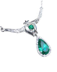 Close view of a natural emerald necklace pear-shaped, accented by natural diamonds 14k white gold
