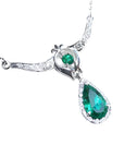 This natural colombian emerald necklace pear-shaped, accented by natural diamonds is made of 14k white gold.